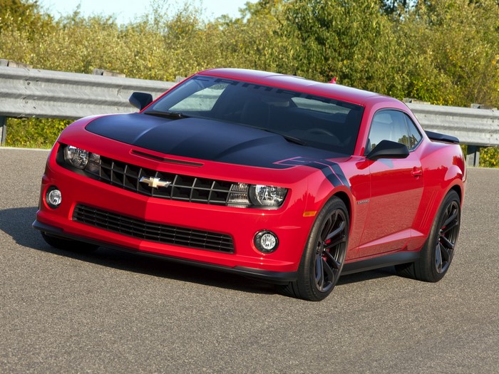 Red Chevrolet Camaro with black accents on a road
