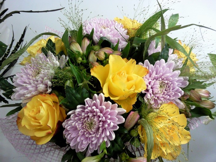 Bouquet of yellow roses and purple chrysanthemums