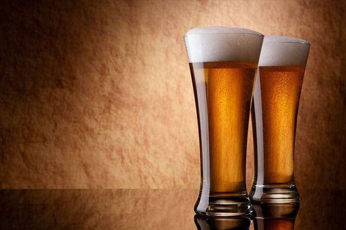 Two glasses of beer with foam