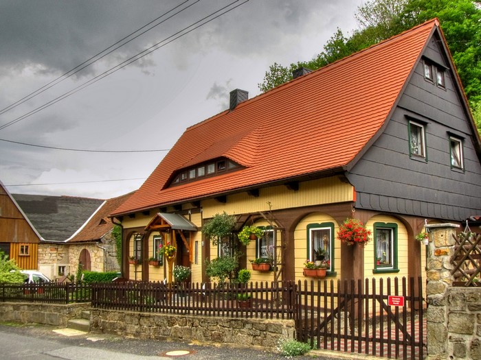 Traditional German house with red roof and yellow facade