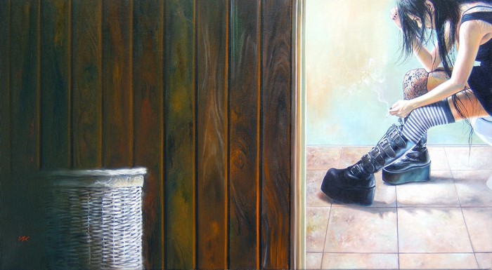 Woman smoking in a room with wooden walls and a laundry basket