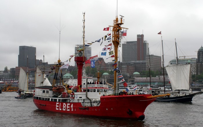 Red ship ELBE 1 and sailboats in Hamburg harbor