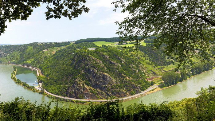 River bend with forested hills and vineyards