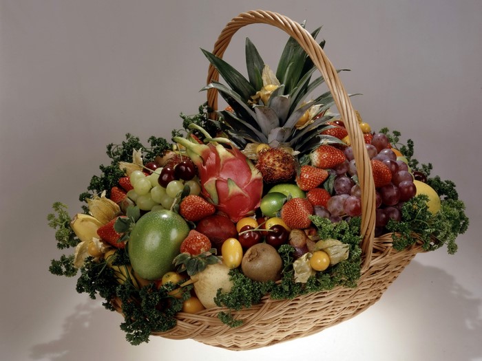 Fruit basket with pineapple, grapes, strawberries, and dragon fruit