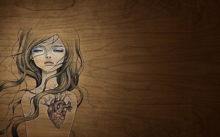 Girl with exposed heart on wooden background