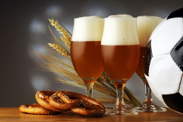 Beer glasses with pretzels and soccer ball