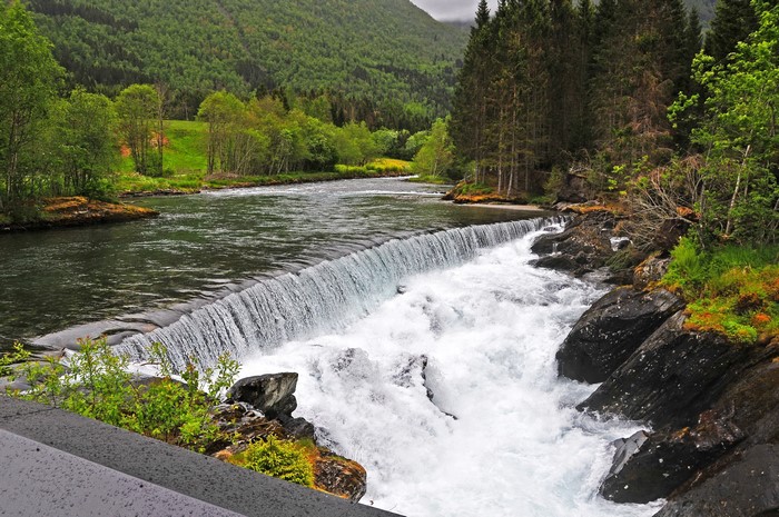 Waterfall in a Forested Mountain Landscape