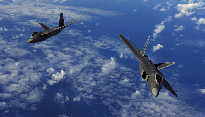 Two F-22A Raptors flying in formation