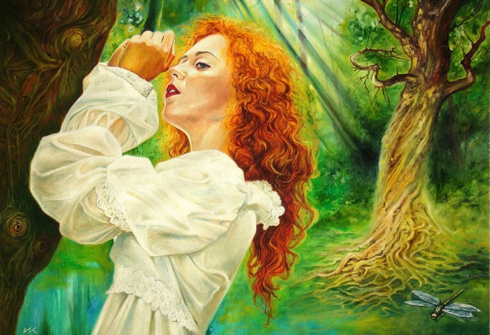 Woman with red hair in a white dress in a forest