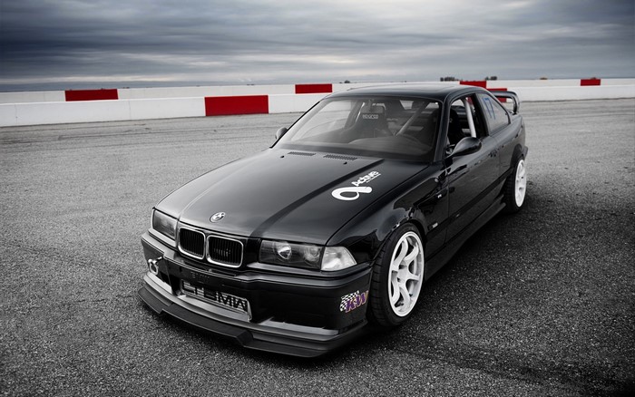 Black BMW M3 E36 on a Race Track