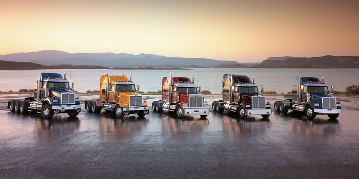 Five Western Star Trucks Lined Up by a Lake