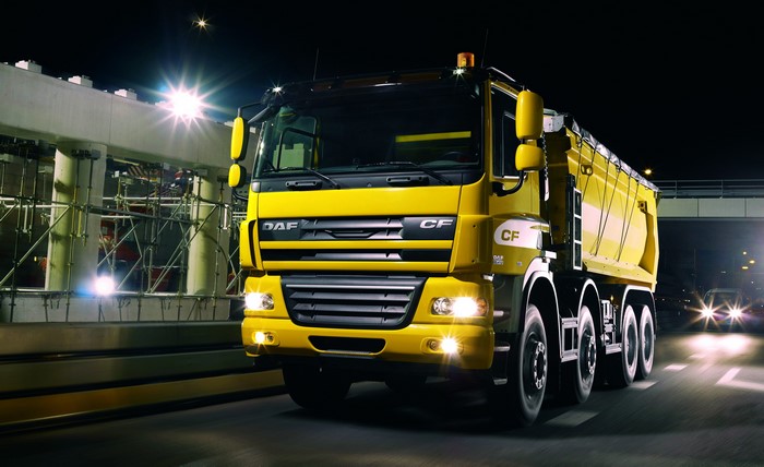 Yellow DAF CF dump truck at night
