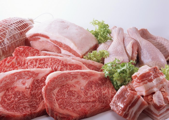 Assortment of raw meats and chicken legs