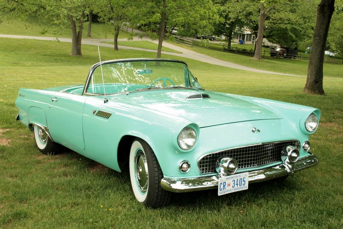 Vintage turquoise Ford Thunderbird convertible on grass