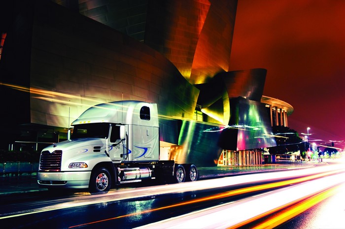 Mack Truck in front of a modern building at night