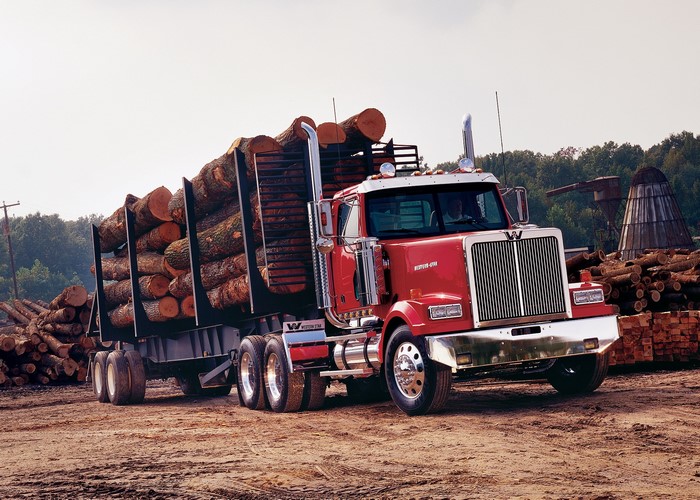 Red Western Star logging truck loaded with logs