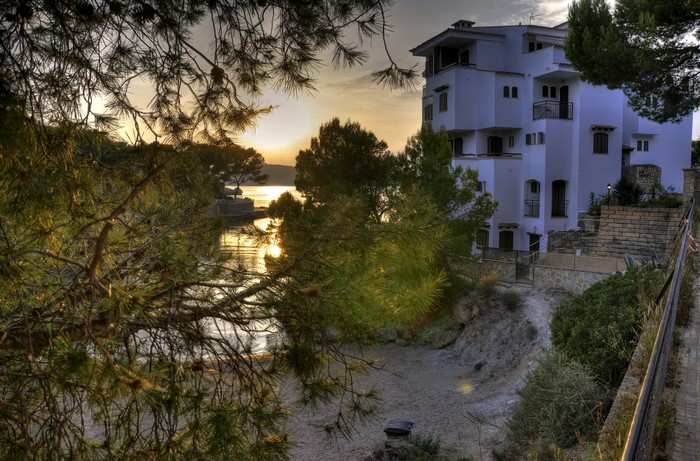 White resort building by the sea at sunset