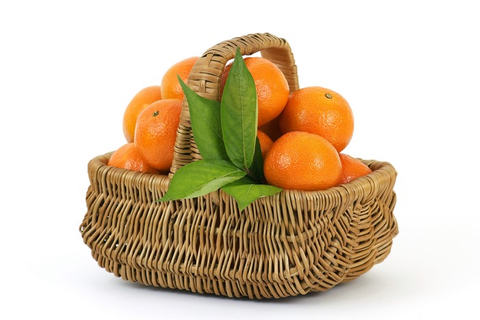Basket of tangerines with leaves