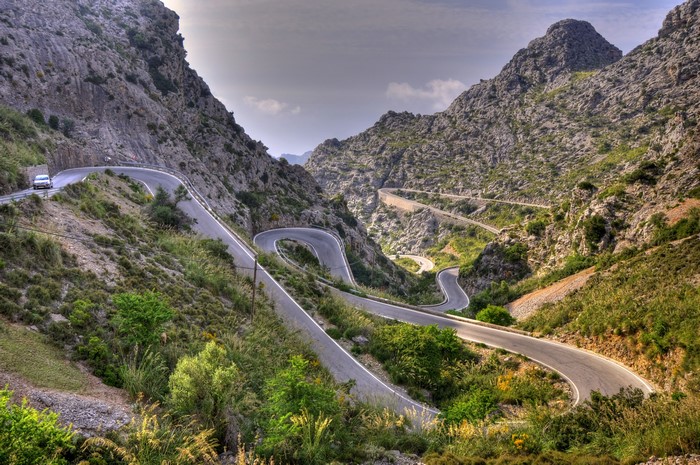 Winding mountain road with a car