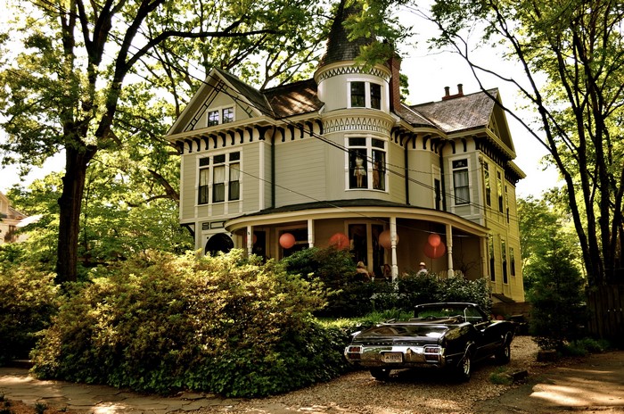 Victorian house with a vintage car