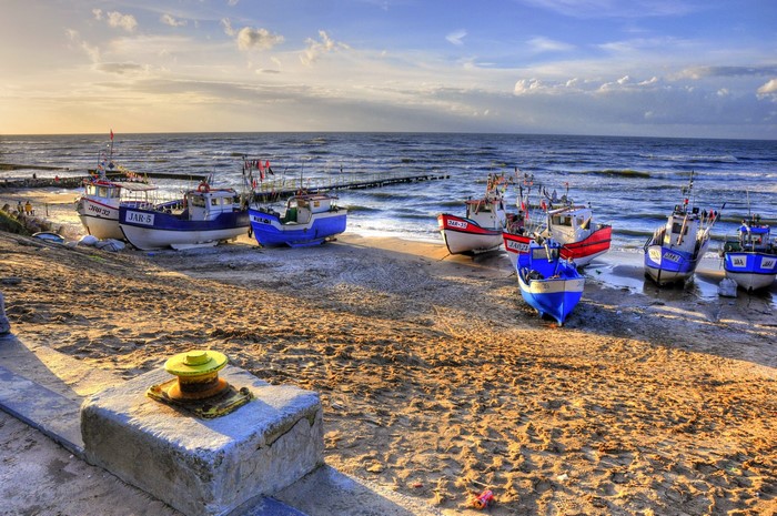 Fishing boats on a sandy beach by the sea