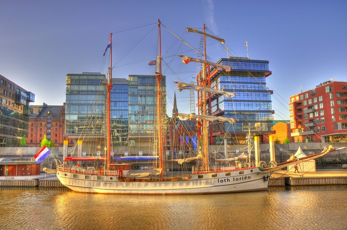 Tall ship Lothlorien docked in a modern harbor