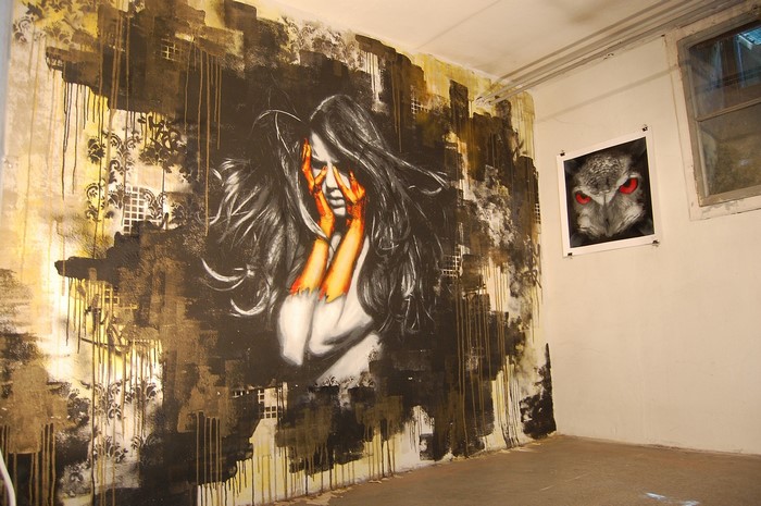 Graffiti mural of a distressed woman and an owl painting