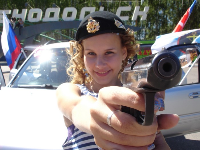 Girl in Beret Holding a Pistol