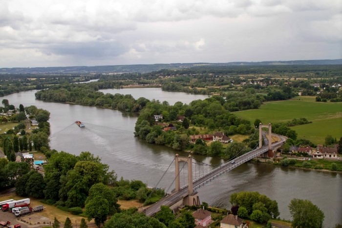 Bridge over a wide river with a barge