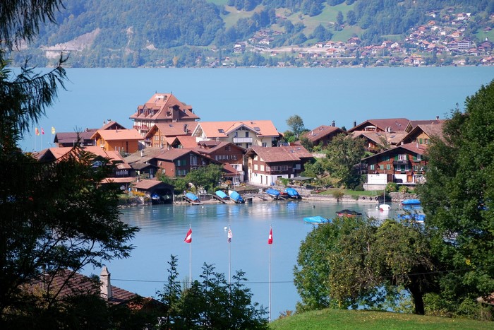 Swiss village on a lake with mountains in the background