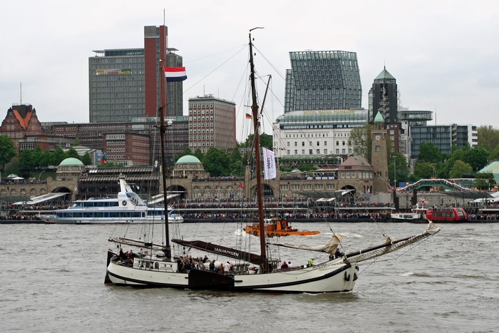 Sailing ship in Hamburg harbor with modern buildings