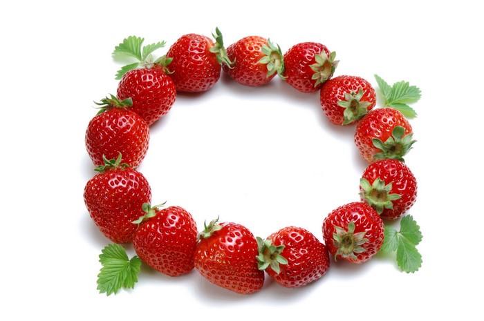 Strawberries arranged in a circle on a white background
