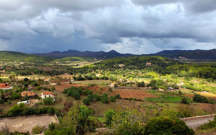 Rural landscape with rolling hills and scattered houses