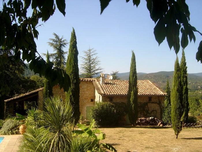 Stone house with cypress trees in France