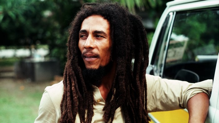 Bob Marley leaning on a car