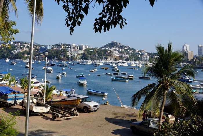 Boats in a bay with a city in the background