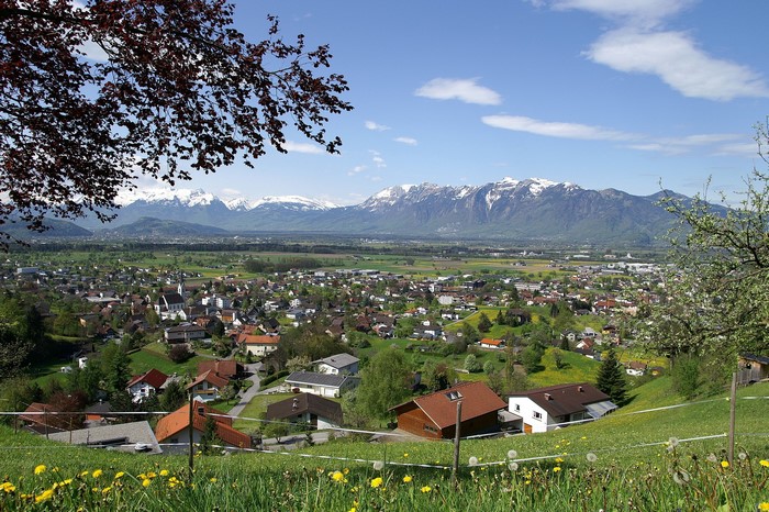 Village with snow-capped mountains in the background