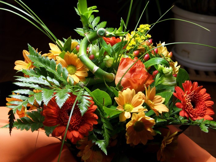 Orange and yellow flowers with bamboo arrangement