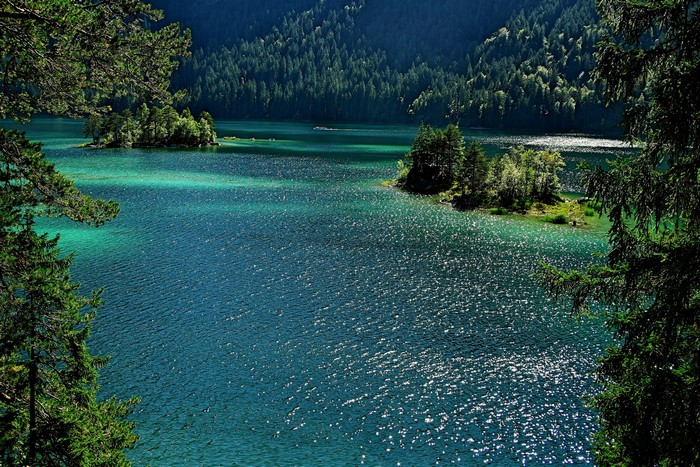 Turquoise lake with islands and evergreen forest