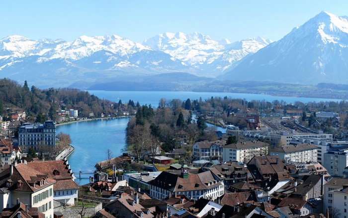 Cityscape with Lake and Snow-Capped Mountains in Switzerland