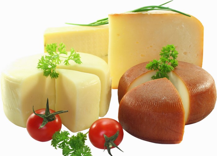 Assortment of cheeses with tomatoes and parsley