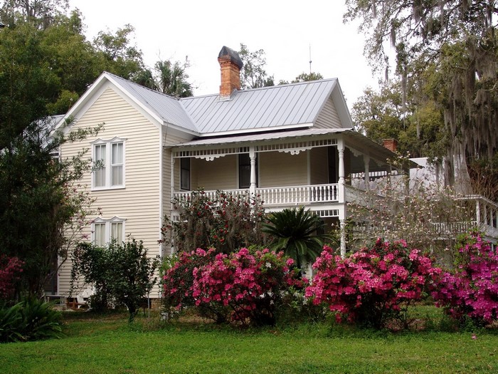 Yellow house with porch and azaleas in Florida