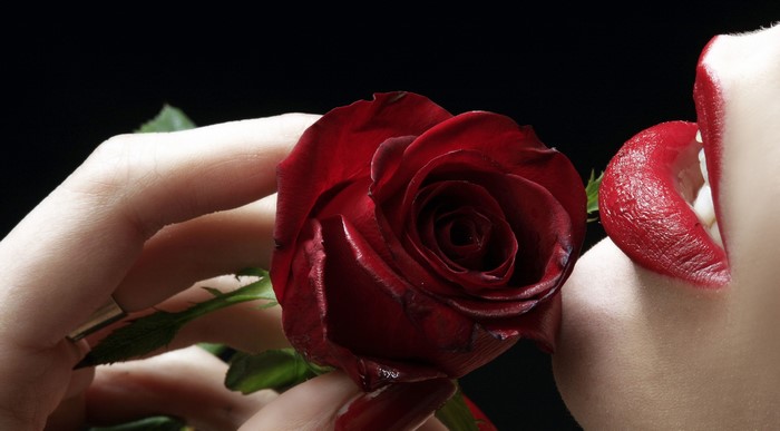 Woman with red lipstick and a red rose