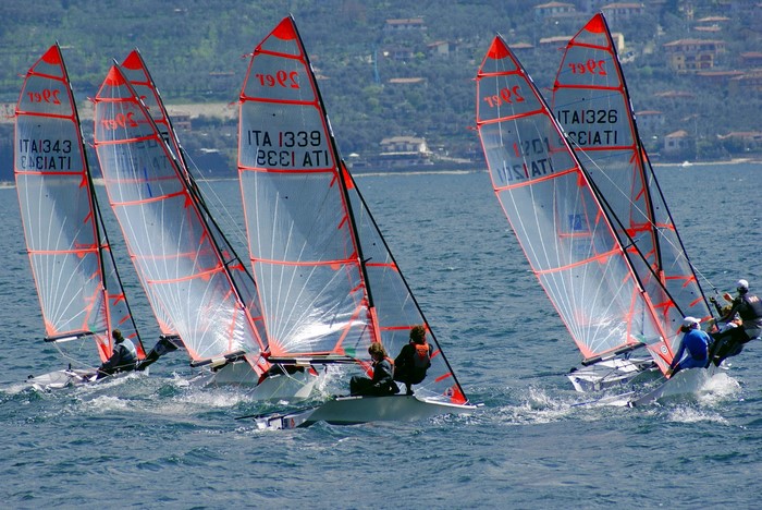 Sailboats racing on a lake with hills in the background