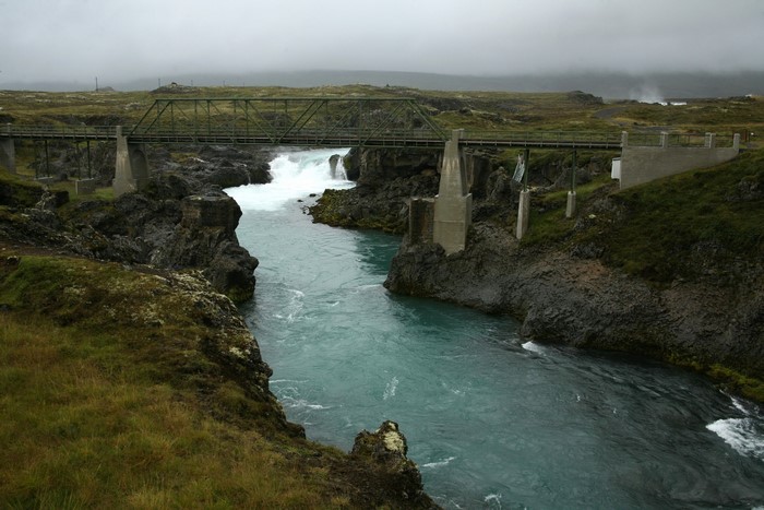 Bridge over a river with waterfalls