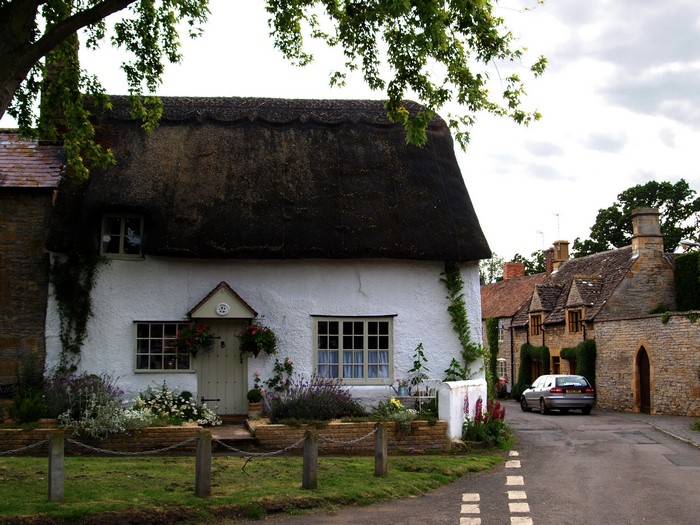 Thatched cottage and stone houses in a village