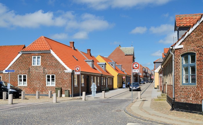 Street in a Danish town with brick houses and orange roofs