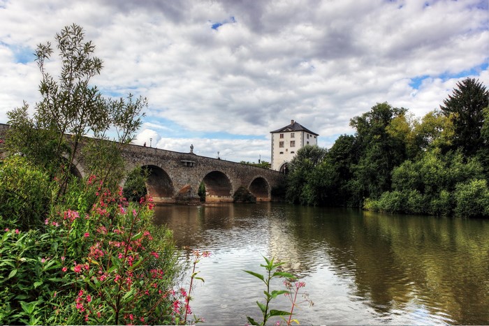 Stone bridge over a river with a tower