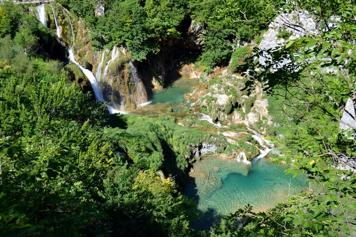 Waterfalls cascading into turquoise pools surrounded by lush greenery