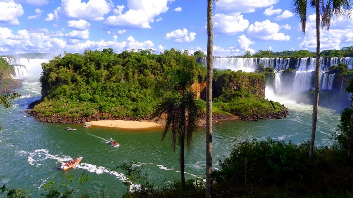 Iguazu Falls with boats and lush greenery